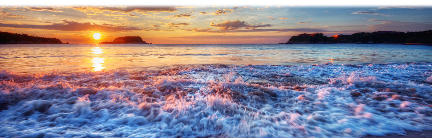 Golden sunset with waves on beach